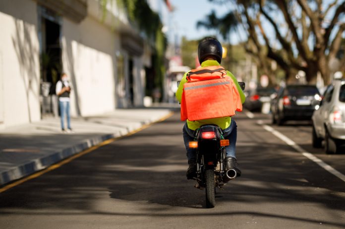 Delivery man riding a motorcycle - motoboy